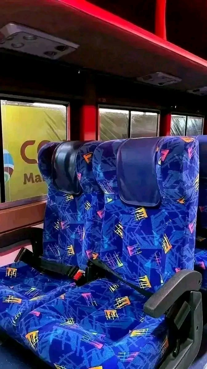 Interior of an Easy Coach bus with reclining seats and belts